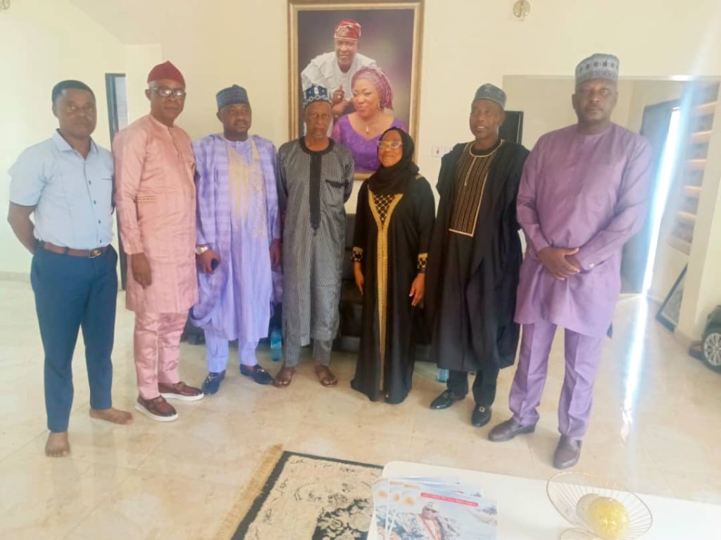 NFRA President Hon. Sani Zubairu and delegation standing with the wife of late Otunba Tade Azeez during a condolence visit