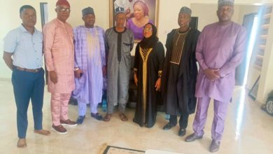 NFRA President Hon. Sani Zubairu and delegation standing with the wife of late Otunba Tade Azeez during a condolence visit