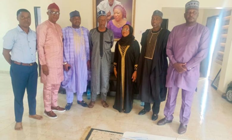 NFRA President Hon. Sani Zubairu and delegation standing with the wife of late Otunba Tade Azeez during a condolence visit