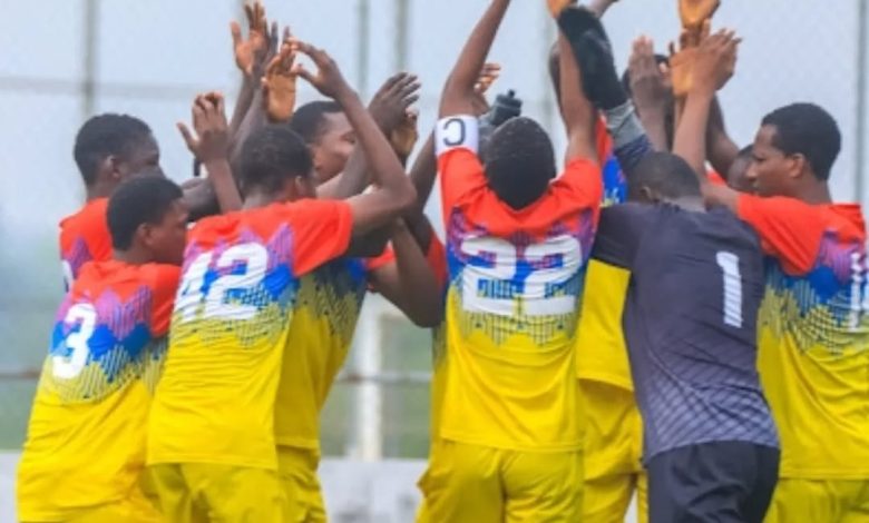 Imperial FC players celebrate passionately after scoring a goal in a Nationwide League One match, showcasing team spirit and youthful energy.