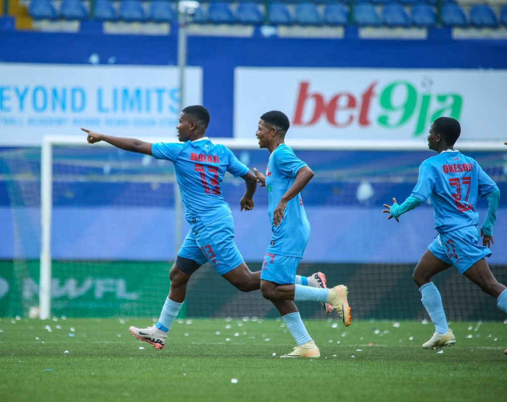 Bolaji Olamide celebrates her goal with hand raised as her Remo Stars Ladies teammates run towards her, smiling and cheering during the NWFL Super 6 match in Ikenne