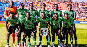 Flying Eagles Prepare for Fierce Quarterfinal Showdown Against Senegal at 2025 CAF U-20 AFCON Nigeria Flying Eagles starting lineup posing for a team photo before their match against Algeria at the CAF U-20 Africa Cup of Nations, with players in green kits standing in two rows on the pitch.