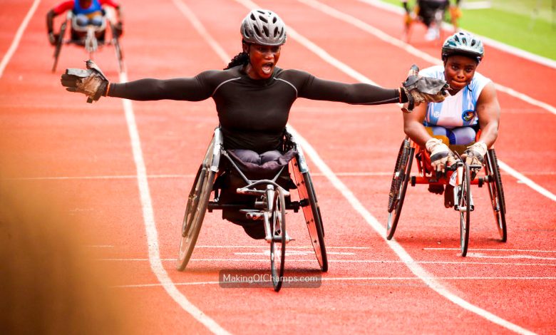 Oluwakemi Oladipo celebrating with her arms spread wide as she crosses the finish line first in the Women's T53-54 100m Wheelchair Race at the Gateway Games 2024