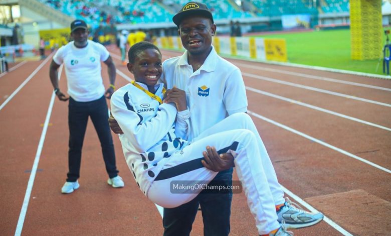 Felix Onoriode joyfully lifts his daughter Bernice after she wins the U17 Girls 100m final at the MTN Champs Grand Final in Uyo