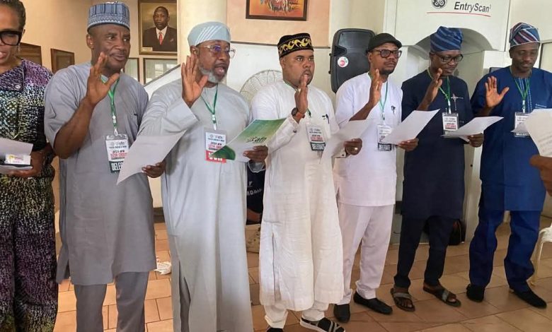 Tonobok Okowa taking oath alongside newly elected AFN Executive Board members during the 2025 Athletics Federation of Nigeria inauguration ceremony in Abuja.