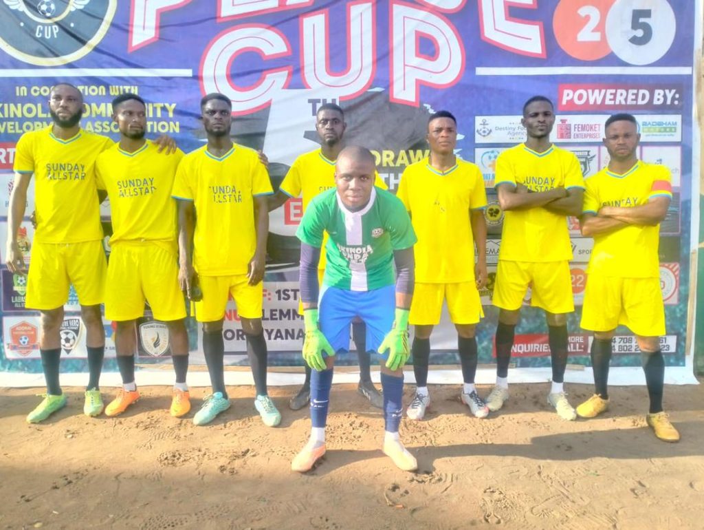 Akinola Sunday Set players lined up before their Peace Cup 2025 match against FC Shindara, wearing their bright orange kits on a sunny afternoon.