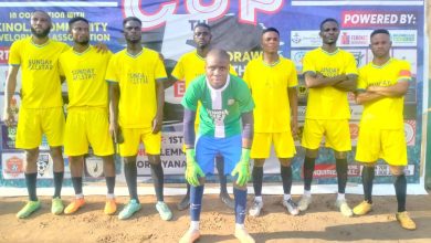 Akinola Sunday Set players lined up before their Peace Cup 2025 match against FC Shindara, wearing their bright orange kits on a sunny afternoon.