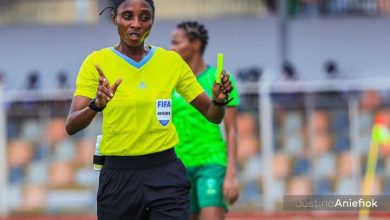 Akintoye Yemisi officiating a match at the NWFL 2024 Super 6 in Nigeria, wearing a referee uniform, focused on the game.