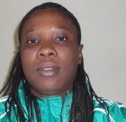 Dr. Asak Diana, Coach of Dannaz Ladies FC, smiling confidently