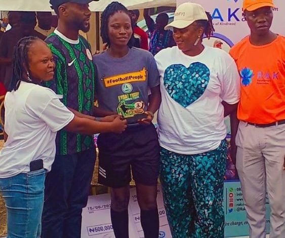 Ashade Senami receiving an award from Hon. Mobolaji Ogunlede, Lagos State Commissioner for Youth and Social Development, during a football event organized by the RAK Development Foundation.