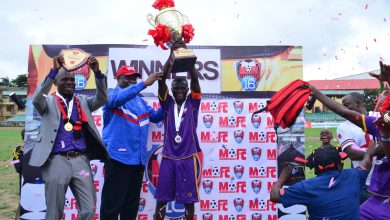 Bishop Mike Okonkwo presents the championship trophy to the winning team at the previous edition of the Mike Okonkwo Football Championship.