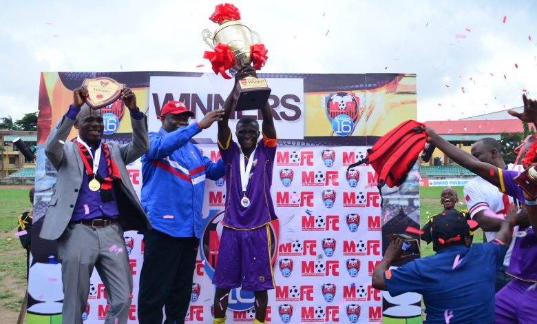 Bishop Mike Okonkwo presents the championship trophy to the winning team at the previous edition of the Mike Okonkwo Football Championship.