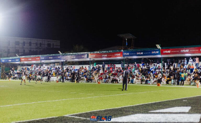 Players in Showtime Flag Football League jerseys competing on a bright green field in Nigeria.