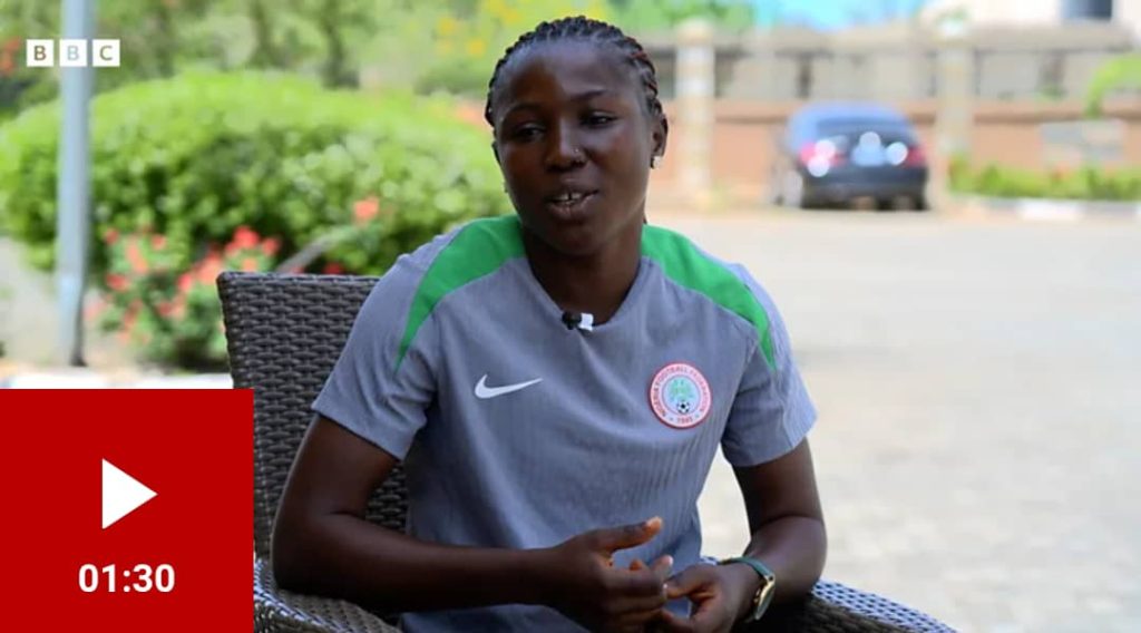 Super Falcons defender Blessing Illivieda speaking to a BBC Pidgin journalist, wearing a Nigeria national team tracksuit, with a determined look on her face