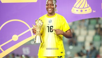 Chiamaka Nnadozie holds her Best Goalkeeper award at WAFCON 2024, smiling in her Super Falcons kit after Nigeria’s semi-final victory.
