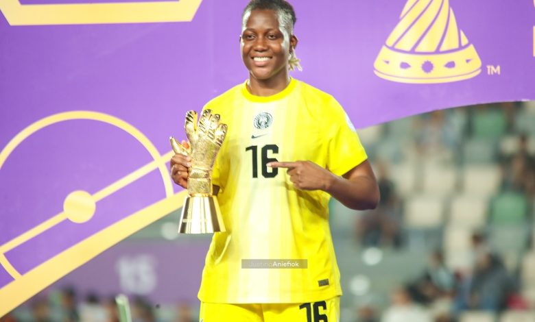 Chiamaka Nnadozie holds her Best Goalkeeper award at WAFCON 2024, smiling in her Super Falcons kit after Nigeria’s semi-final victory.