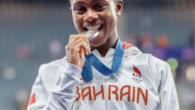 Salwa Eid Naser bites her gold medal after winning the Zurich Diamond League women’s 400m.